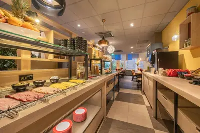 a restaurant with a counter with food on display at Leonardo Boutique Hotel Amsterdam Vondelpark in Amsterdam