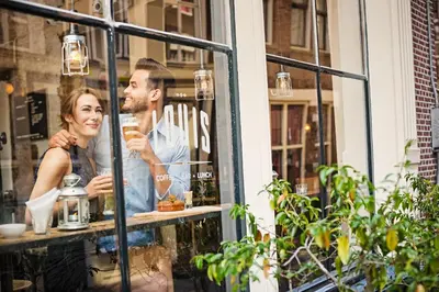 a man and woman looking in the window of a store at The Highlander Amsterdam in Amsterdam