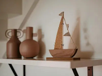 a small wooden boat sitting on a shelf at Lakehouse I in Uitgeest