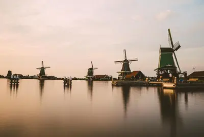 a group of windmills sitting in the water at Renovated Parkside Gem - 2 person studio in the Pijp in Amsterdam