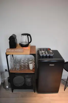a kitchen with a coffee maker and a stove at Rembrandtplein house A in Amsterdam