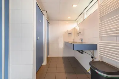 a bathroom with a sink and a toilet at Glamping de Hof van Eeden in Warmond