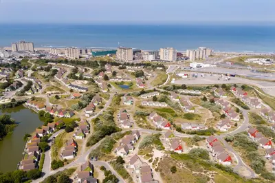an aerial view of a park next to the ocean at Beachhotel Zandvoort by Center Parcs in Zandvoort