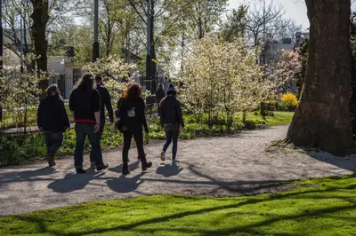 people walking down a path in a park at Hotel Park Plantage in Amsterdam
