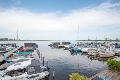 a bunch of boats docked in a harbor at Meerzicht 71 - Perfectly suited for 6 persons in Uitgeest