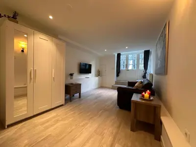 a living room with a couch and a table at Tulip House Luxury Apartment - Top Location - Rijksmuseum - Leidseplein AMSTERDAM Central 120 m2 ALL Private with kitchen in Amsterdam