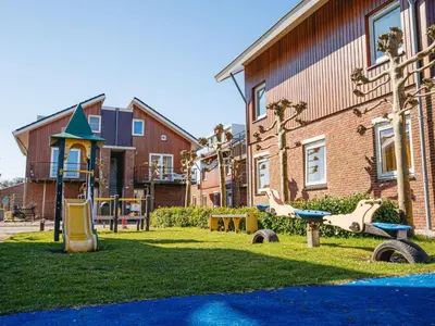 a playground in front of a building at Apartment Oostergeest by Interhome in Uitgeest