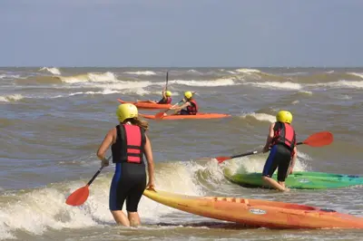 a group of people kayaking in the ocean at Stayokay Hostel Noordwijk in Noordwijk