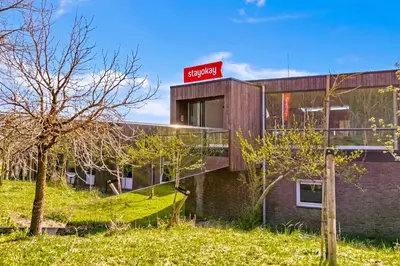 a building with a sign on the side of it at Stayokay Hostel Noordwijk in Noordwijk