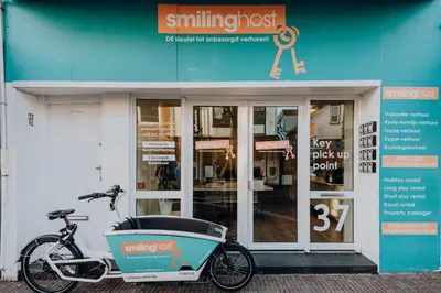a bike parked in front of a shop with a cooler on it at Villa Harry with private parking in Zandvoort