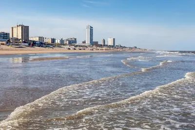 a view of the beach with a city in the background at Ceebee - Free parking in Zandvoort