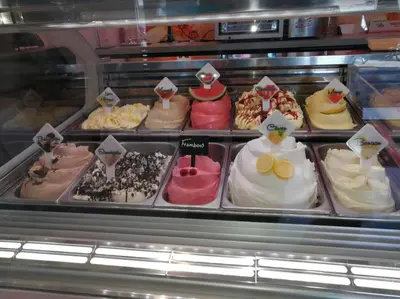 a display case filled with lots of different types of cakes at Studio Bergen in Bergen