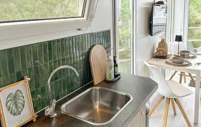 a kitchen with a sink and a window at Davy Jones in Almere