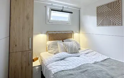 a small bedroom with a bed and a window at Davy Jones in Almere