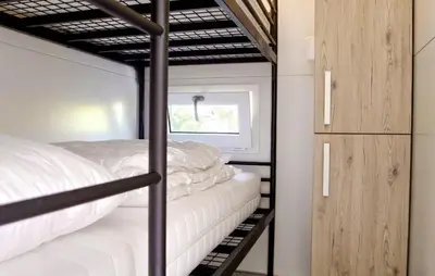a bedroom with two bunk beds and a window at Davy Jones in Almere