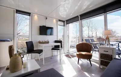 a living room with a table and chairs at Davy Jones in Almere