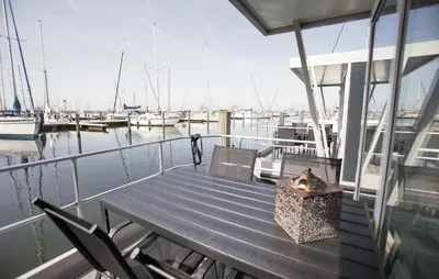 a dog sitting on a bench on a boat at Barbossa in Almere