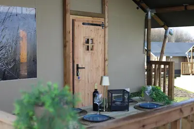 a table with two sinks in front of a door at Safari Lodges XL in Nieuwe Wetering