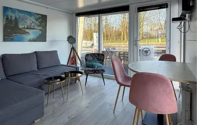 a living room with a couch and a table and chairs at Amsterdam in Naarden