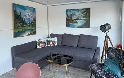 a living room with a couch and a table at Stellenbosch in Naarden