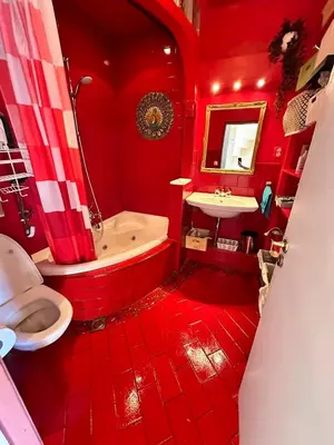 a red bathroom with a tub and a sink at Terraced Bedroom in Utrecht