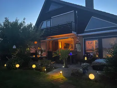 a house with a patio with lights in the yard at 1-2 P Room near Airport AMS freeparking in Roelofarendsveen