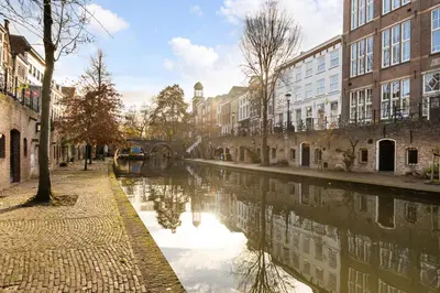 a canal in the middle of a city with buildings at Luxurious canal apartment in Utrecht A Location in Utrecht
