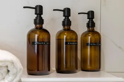 three bottles sitting on a shelf in a bathroom at Luxurious canal apartment in Utrecht A Location in Utrecht