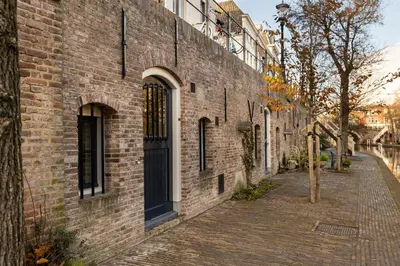 a brick building with a door on a street at 4P Unique canal apartment A Location in Utrecht in Utrecht