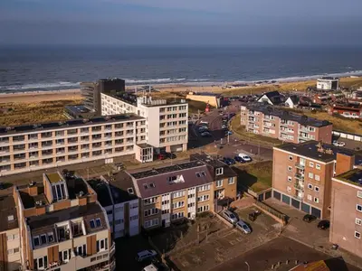 an aerial view of a city and the ocean at Strand appartement aan zee met 2 parkeerplekken! in Egmond aan Zee