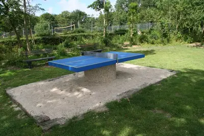 a blue bench in a field with a park at Rekerlanden 260 in Schoorldam