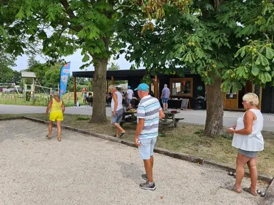 a group of people playing a game in a park at Chalet 552 op Recreatiepark De Wielen in Sint Maarten