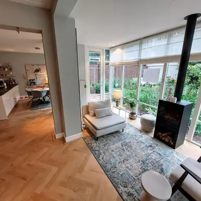 a living room with a couch and a fireplace at 185m2 groot appartement met tuin in City Centre in Amsterdam