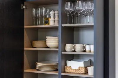 a cupboard filled with dishes and wine glasses at De Kroonkamer in Loenen aan de Vecht