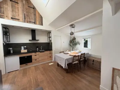 a kitchen and dining room with a table and chairs at Stolp & Stay in Broek in Waterland