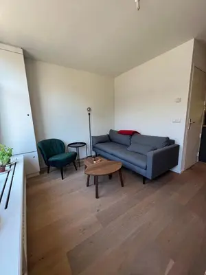 a living room with a couch and a table at Museum district, beautiful renovated house in Amsterdam