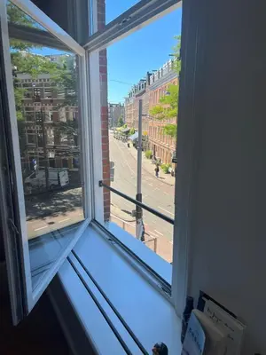 a window with a view of a street at Museum district, beautiful renovated house in Amsterdam