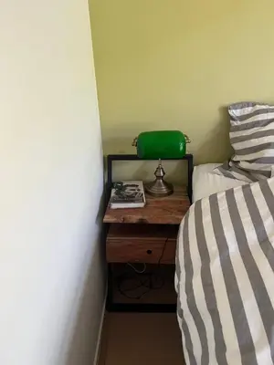 a bedroom with a bed and a table with a green bag at Museum district, beautiful renovated house in Amsterdam