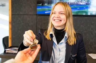 a woman is holding a object in her hand at EuroParcs Bad Hulckesteijn in Nijkerk