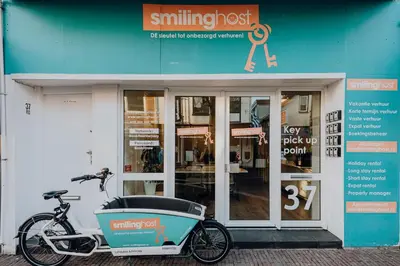 a bike parked in front of a building at Therese with free parking in Zandvoort