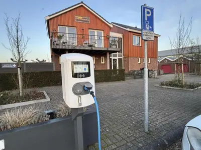 a parking meter on the side of a street at Apartment Westergeest 2 by Interhome in Uitgeest