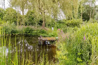 a bird sitting on a dock in the water at Reijgershof - The Barok lounge in Amsterdam