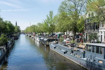 a canal with boats parked on the side of it at Executive Houseboat-Apartment Sumatra in Amsterdam