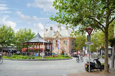 a moped parked in front of a building with a gazebo at Studio Elysium in Zandvoort