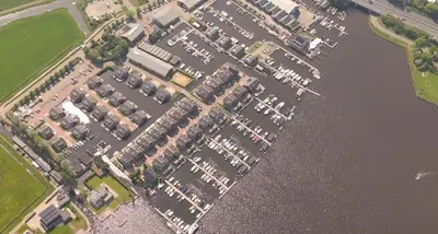an aerial view of a parking lot next to the water at Houseboat Plus Uitgeest in Uitgeest