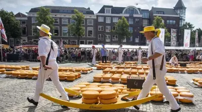two men walking past a bunch of hot dogs on surfboards at Houseboat Woude Uitgeest in Uitgeest