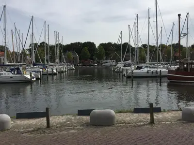 a group of boats docked in a marina at Holiday Home Charmantes Ferienhaus Hilda mit Terrasse by Interhome in Wervershoof
