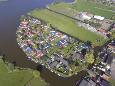 an aerial view of a group of houses by the water at Holiday Home by Interhome in Wervershoof