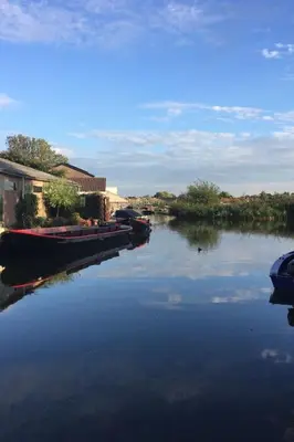 a group of boats docked on a river at Holiday Home in Wervershoof mit Sonniger Terrasse by Interhome in Wervershoof