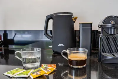 a coffee maker and two cups of tea on a counter at 2 Luxurious Studios in Utrecht City Center in Utrecht